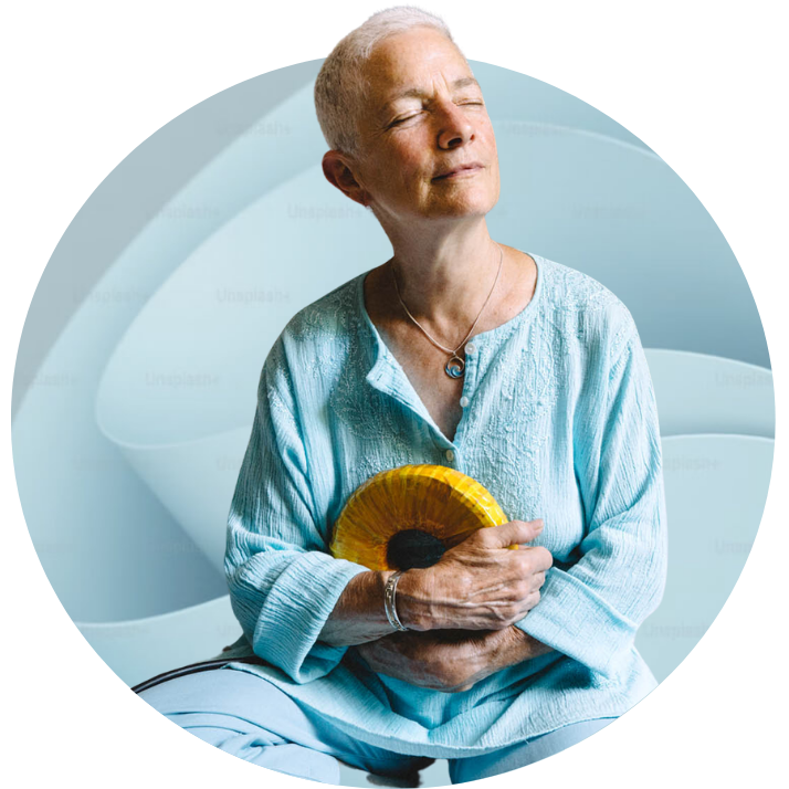 Person relaxing while holding an AmpCoil electromagnetic coil during a wellness session.